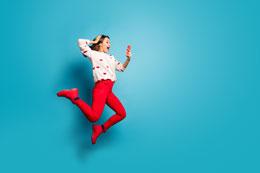 woman jumping excited looking at mobile 260x173