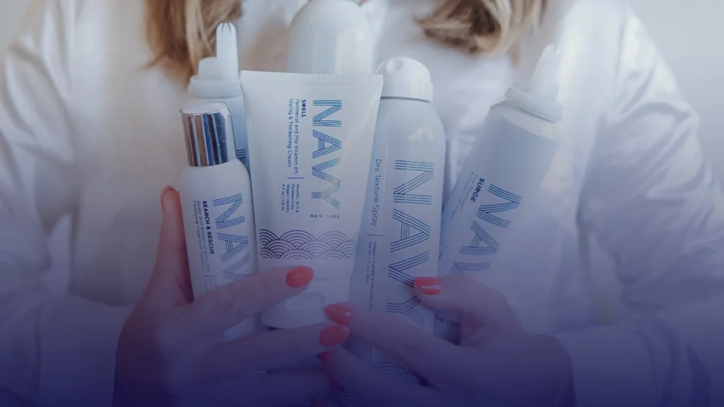 navy hair care products in a woman's hands