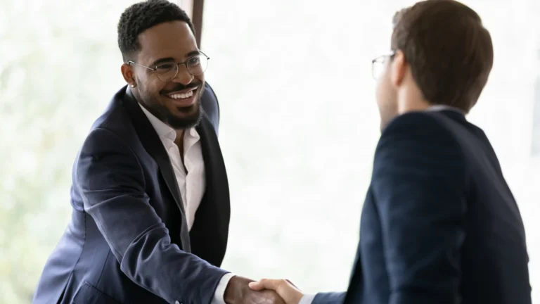 team members shaking hands in a finance meeting