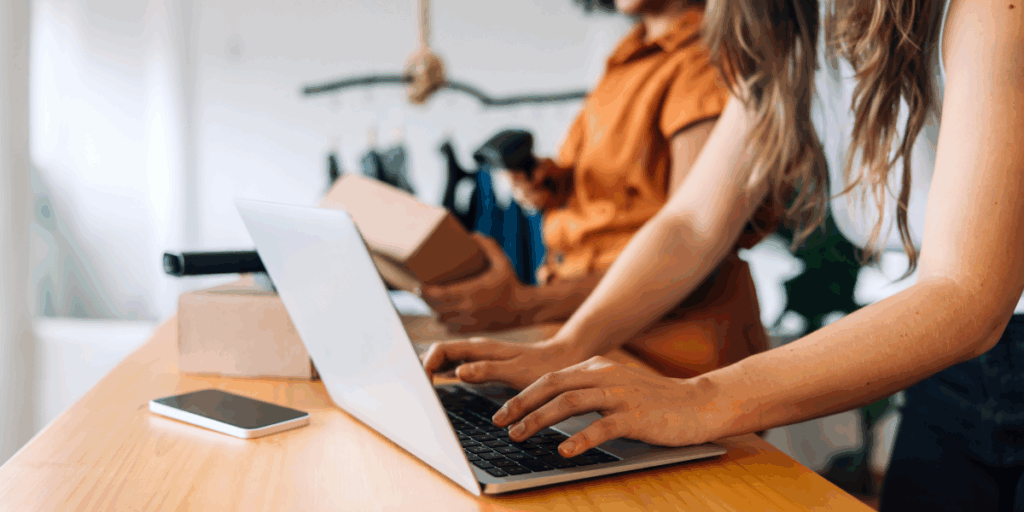 People in office, working at laptops and mastering the art of social selling