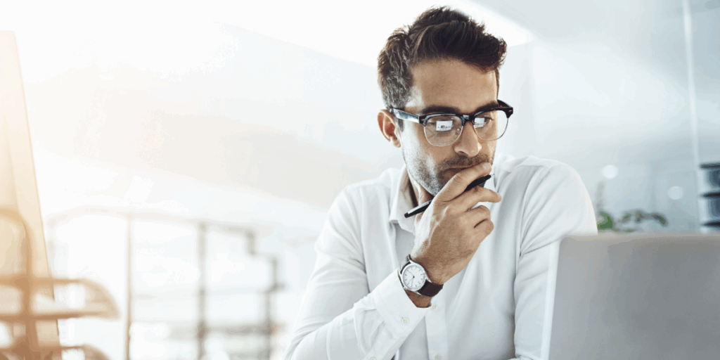 Man looking at laptop, analysing his social search strategy
