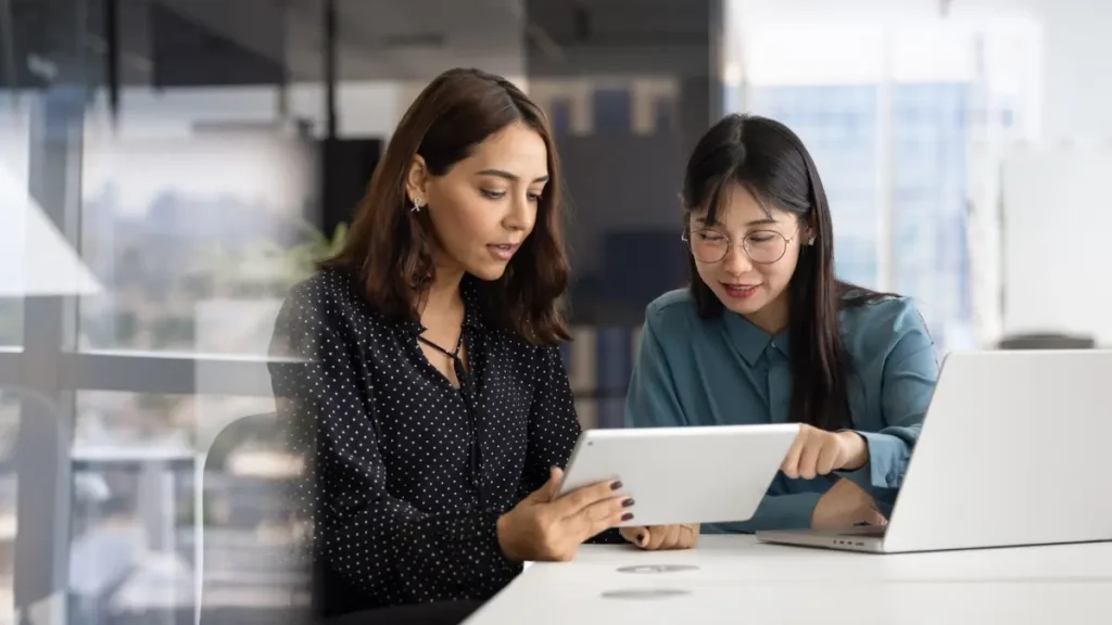Two colleagues looking at unified analytics