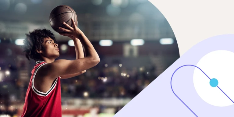 Sports club social media benchmarks: basketball player in a red jersey lining up a shot in a floodlit arena